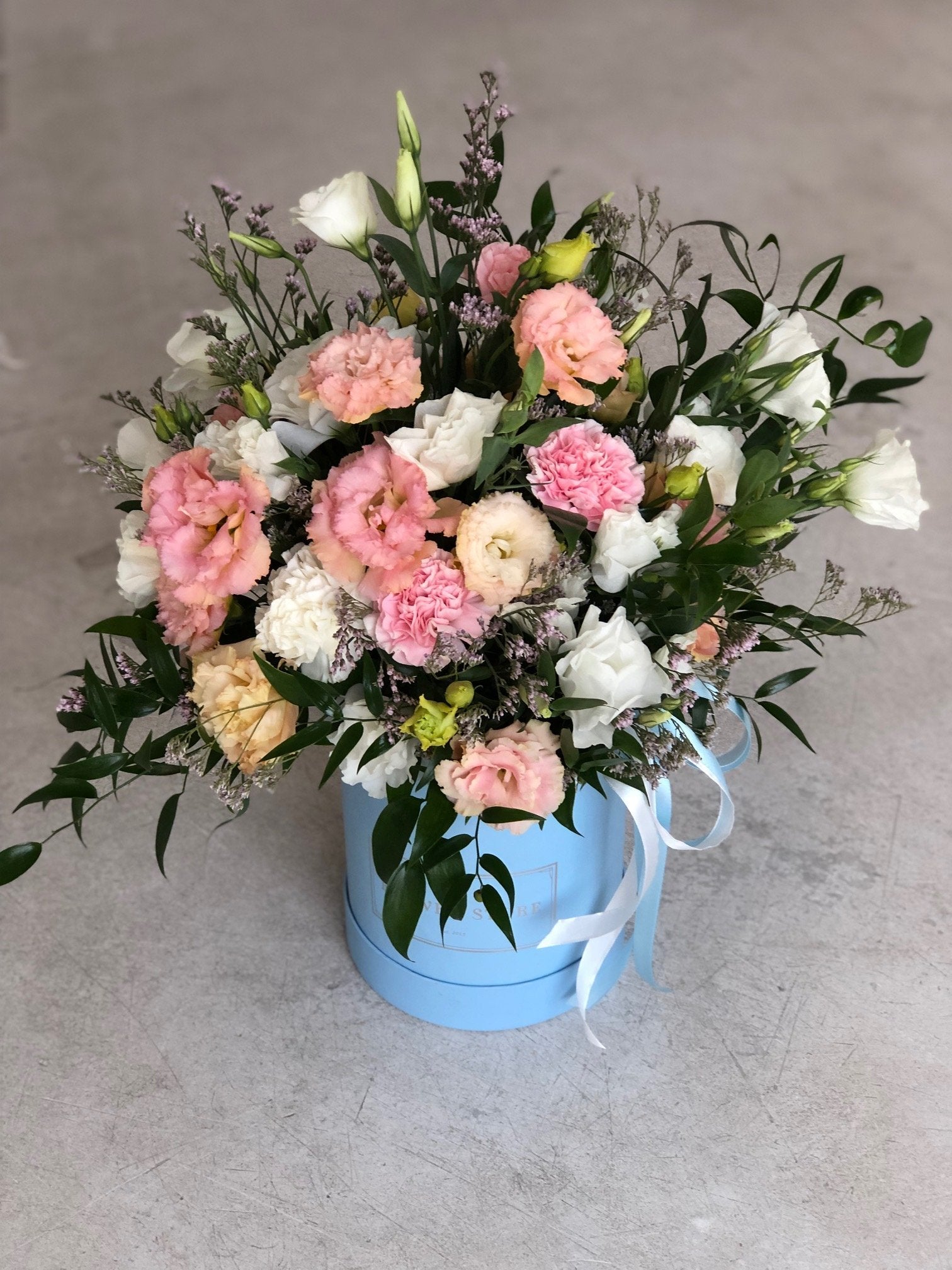 Airy spring composition in a large blue flowerbox - live flowers