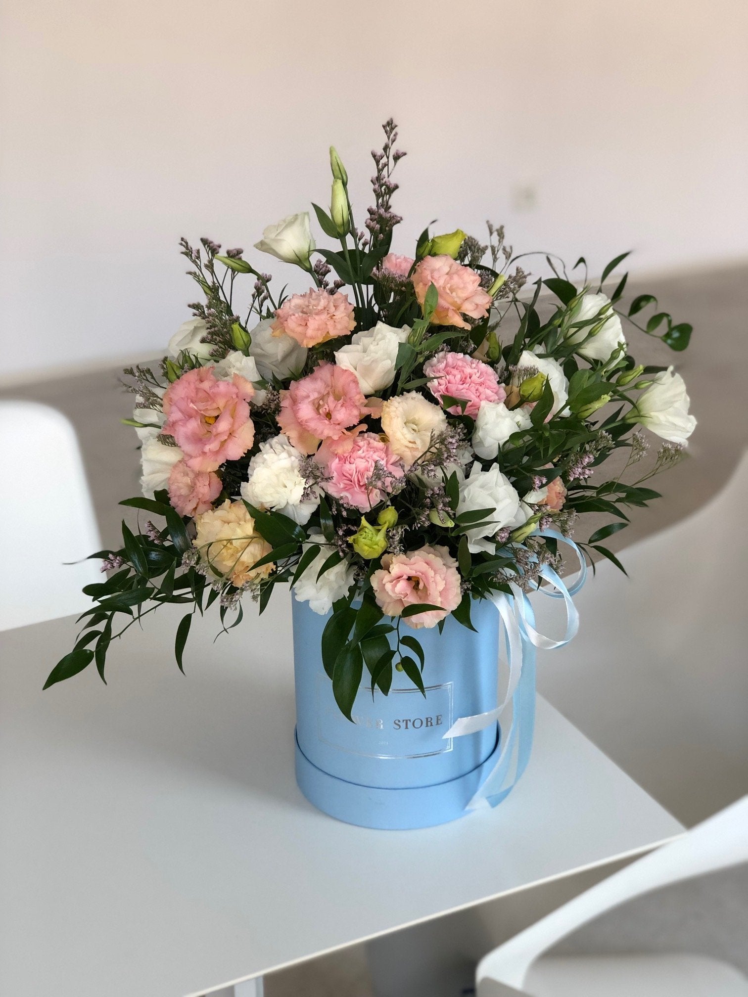 Airy spring composition in a large blue flowerbox - live flowers