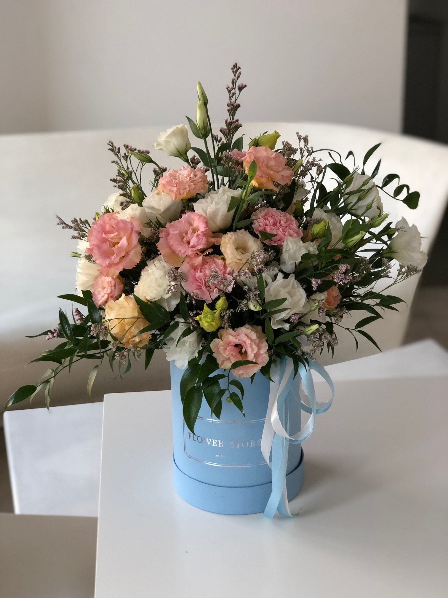 Airy spring composition in a large blue flowerbox - live flowers