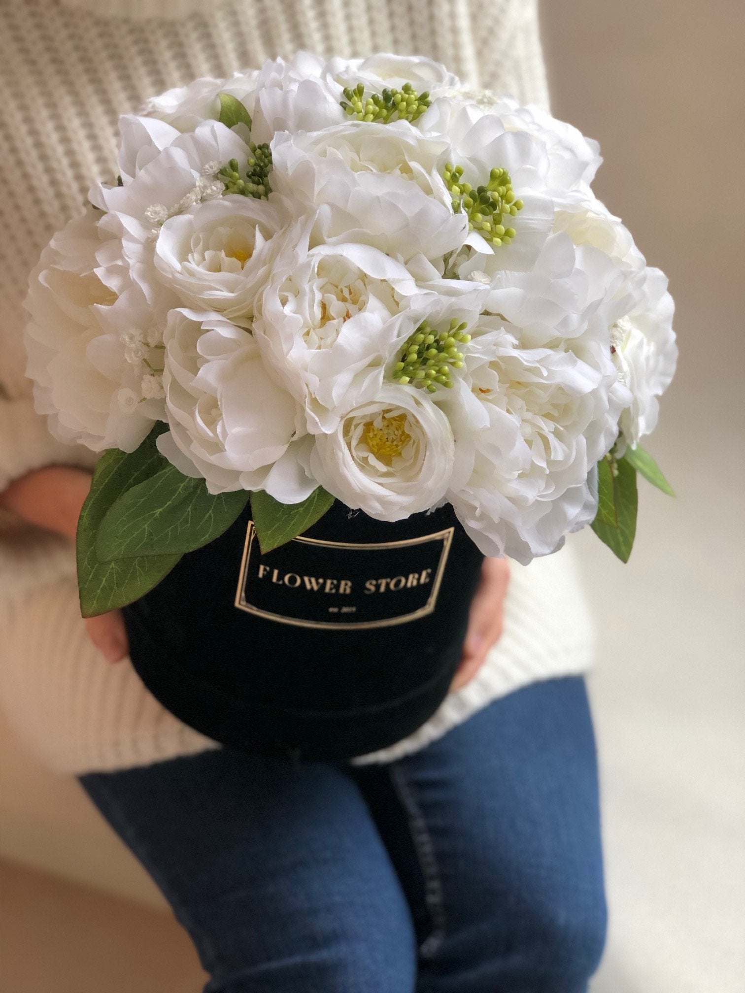 Black flocked box with a white and cream composition - artificial flowers