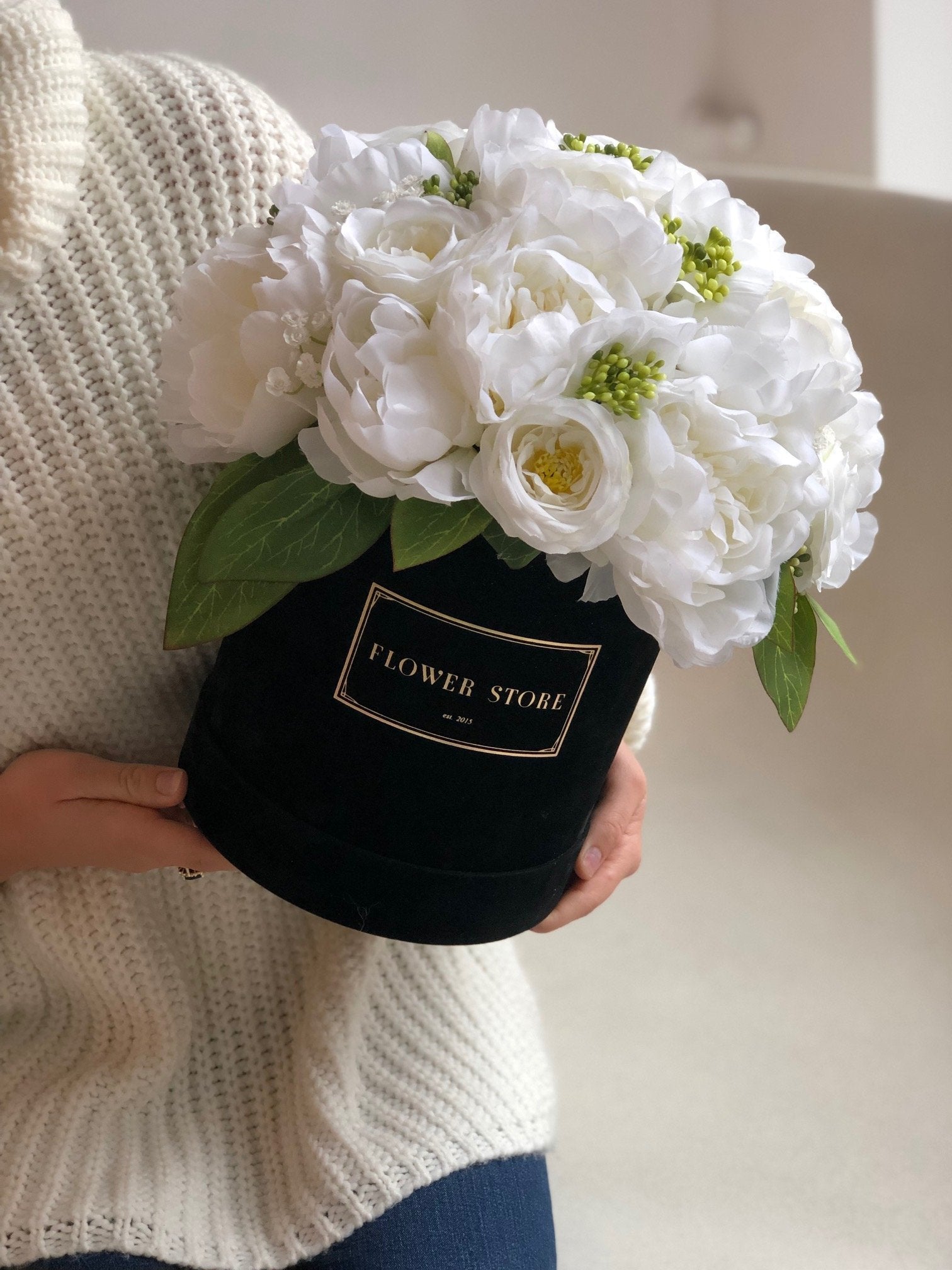 Black flocked box with a white and cream composition - artificial flowers