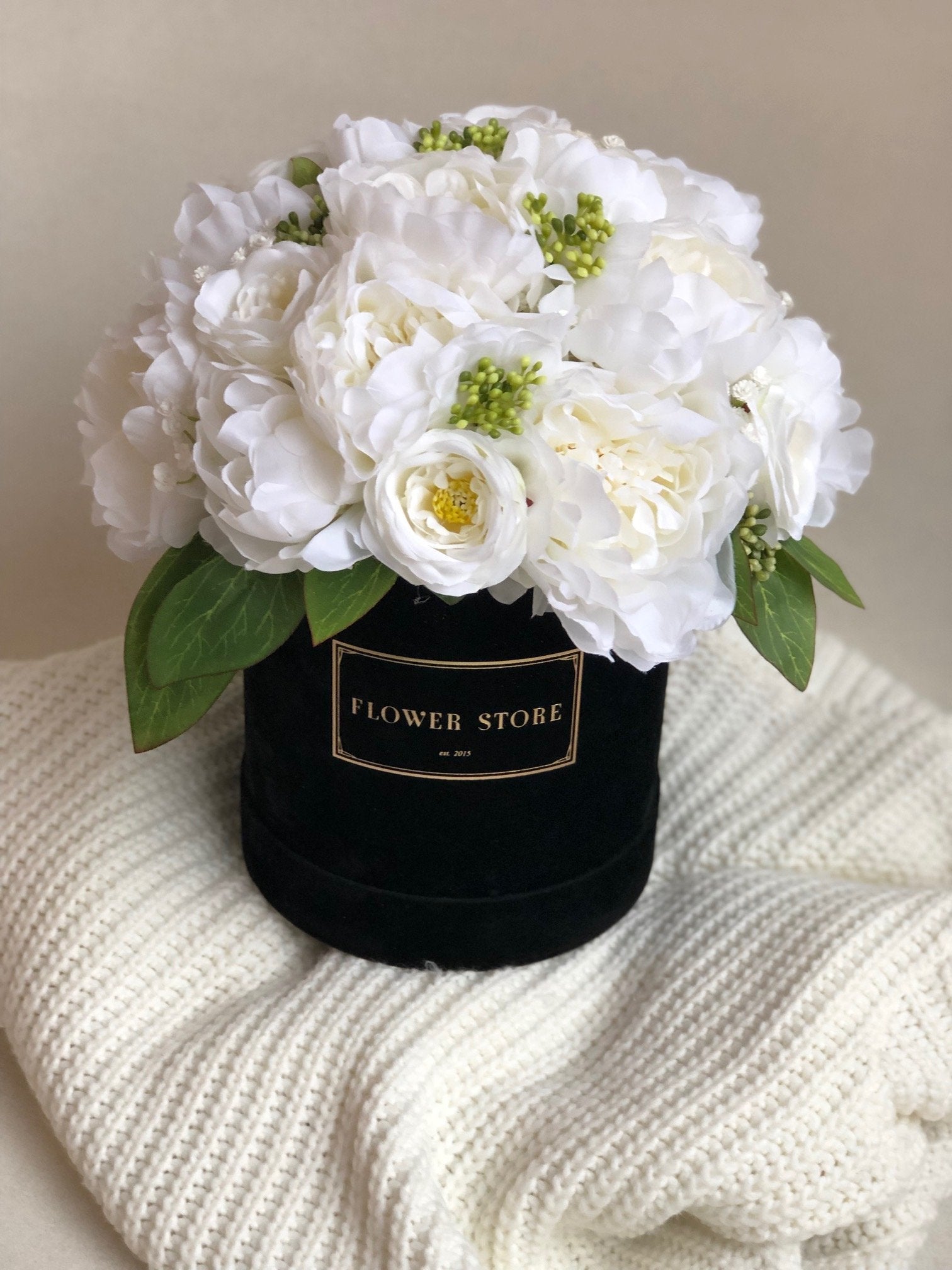 Black flocked box with a white and cream composition - artificial flowers