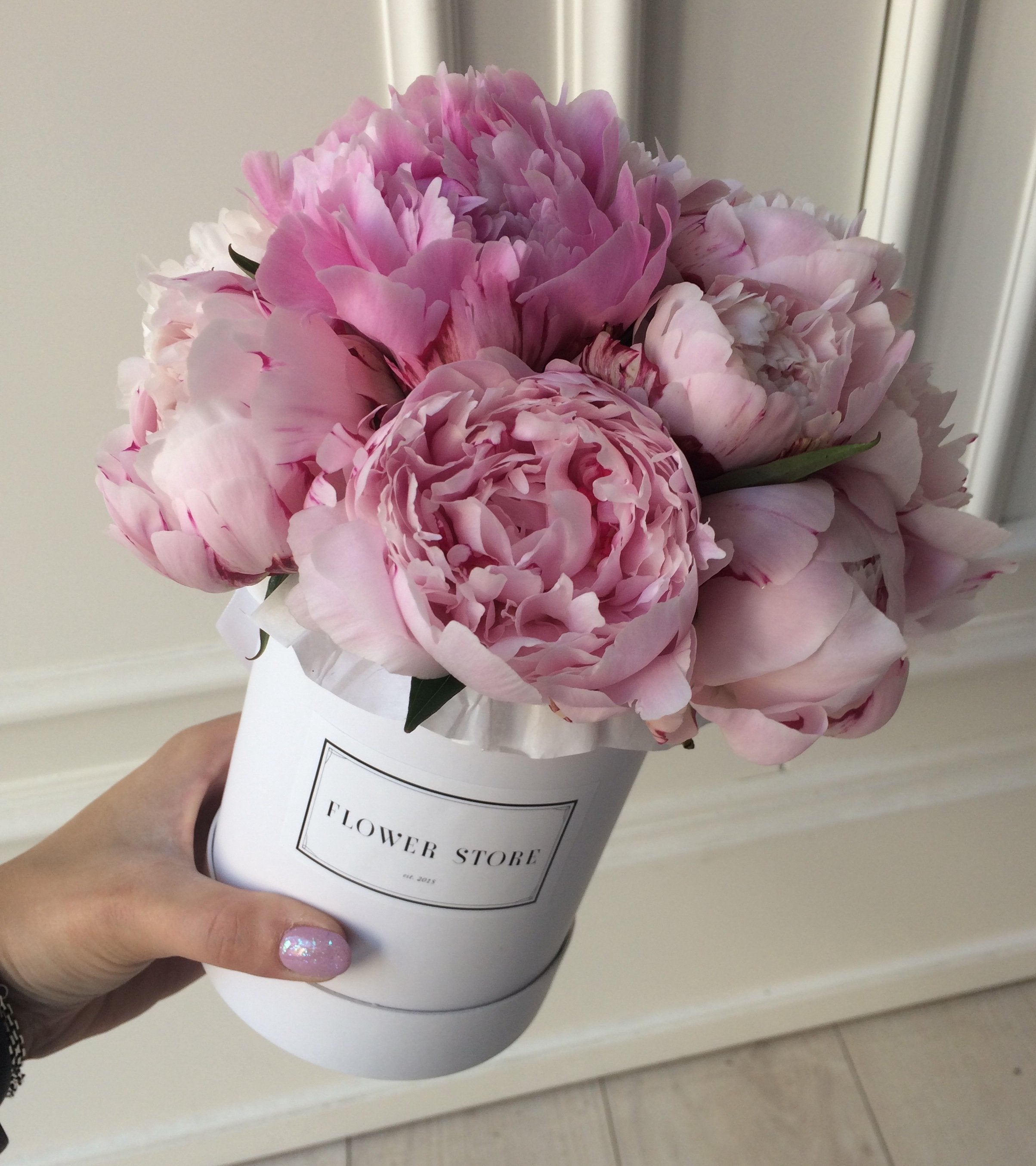 A small white box with peonies - live flowers