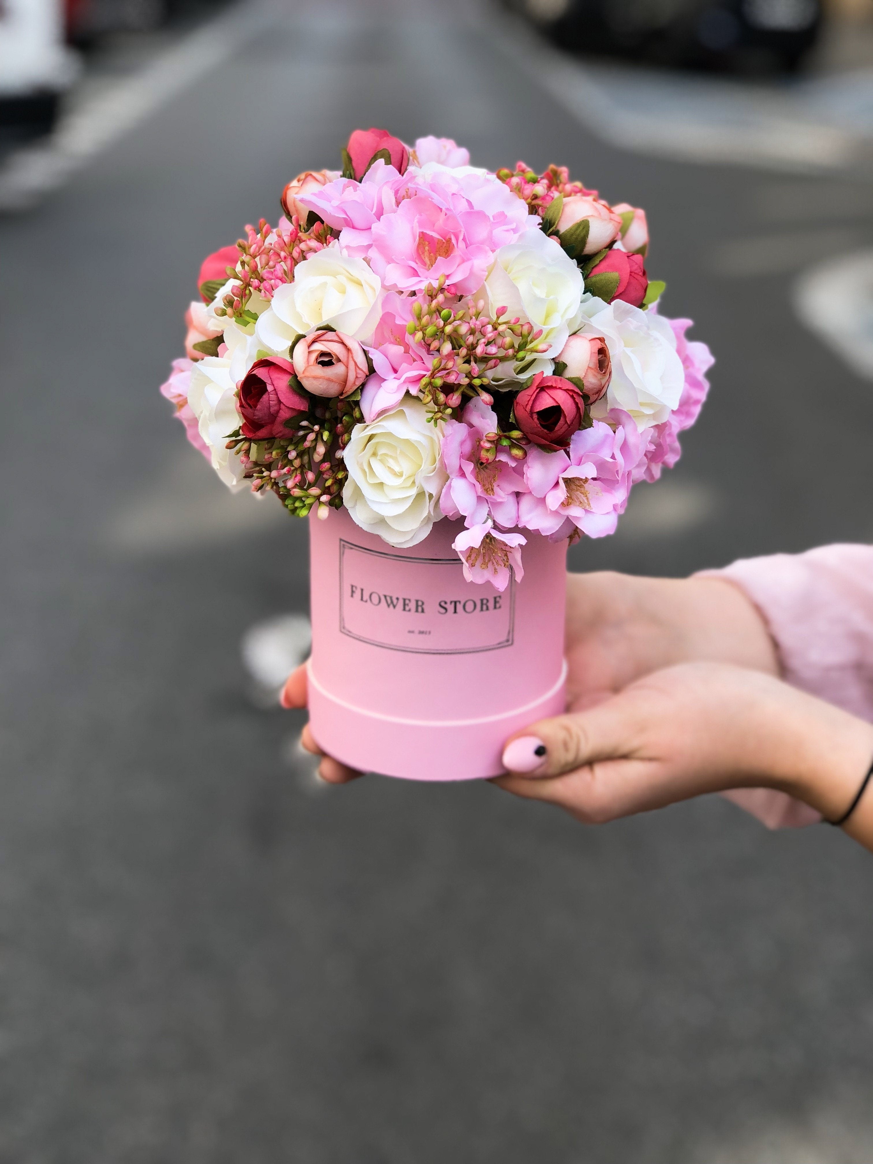 A small pink box with a spring composition - artificial flowers