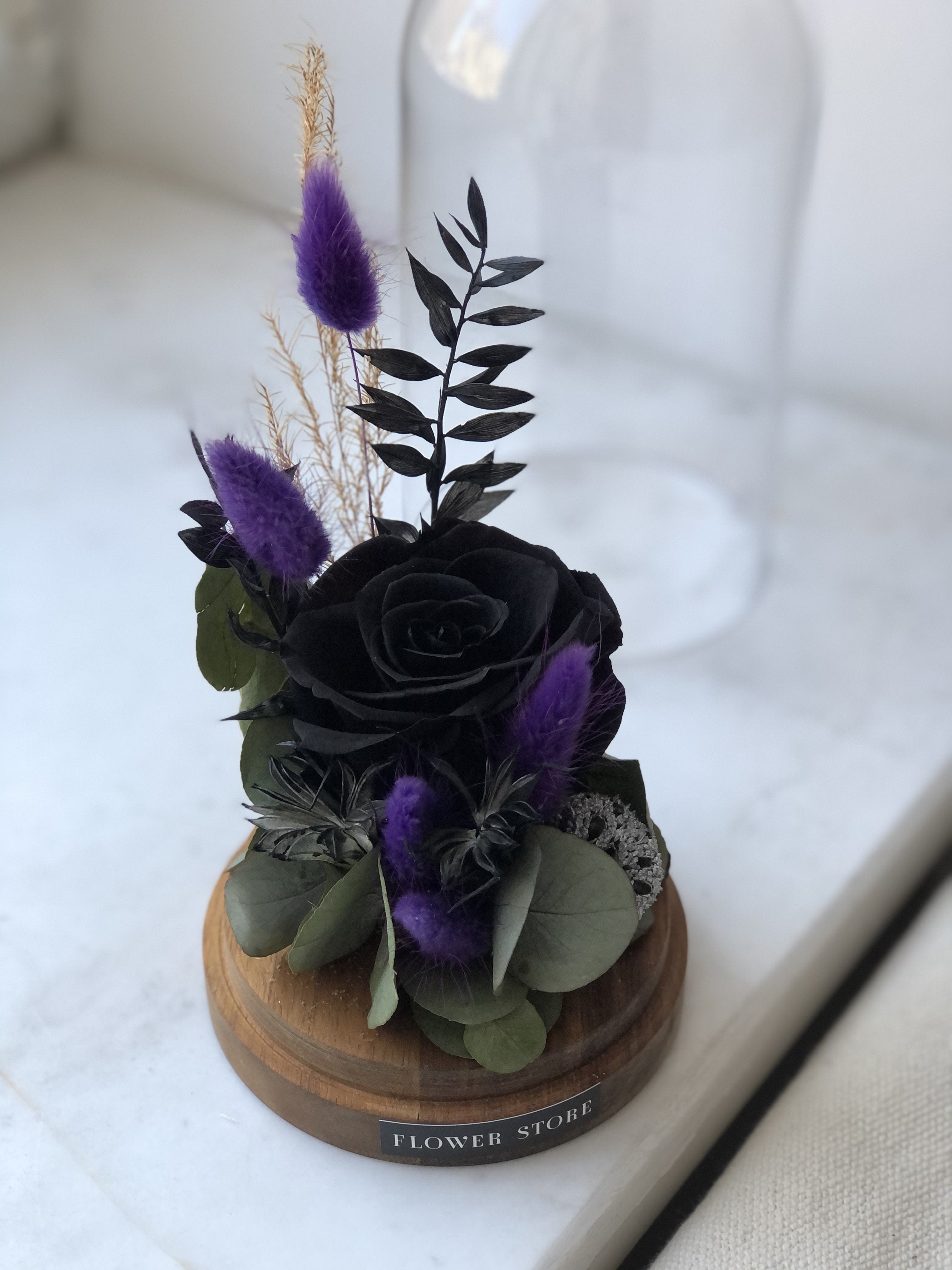 Dried composition with black eternal rose in glass